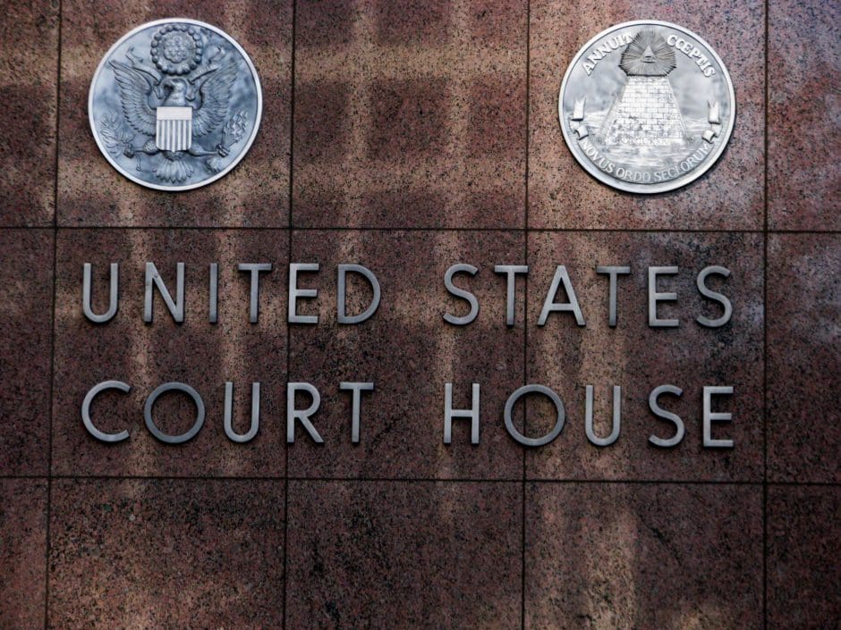 Image of brown wall with the words United States Court House on the side. 