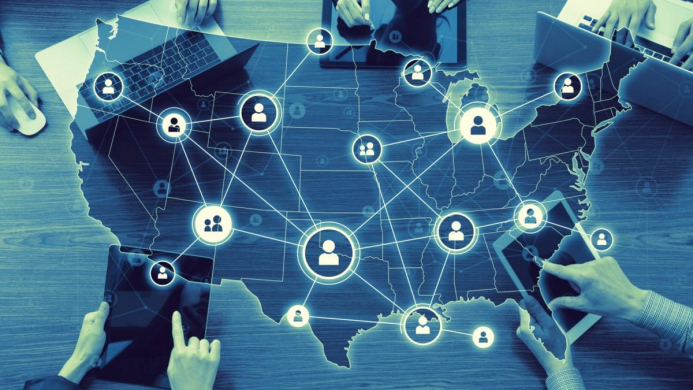 Computer,Network,Of,United,States,Of,America. Picture of United States in Blue and Green with nodes connecting people icons across the country. There are also people's hands visible on the borders of the image.
