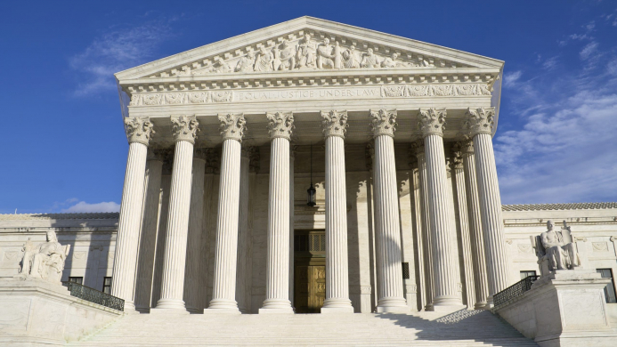 Supreme,Court,Building,In,Washington,,Dc,With,A,Blue,Sky Picture of the Supreme Court building during the day.